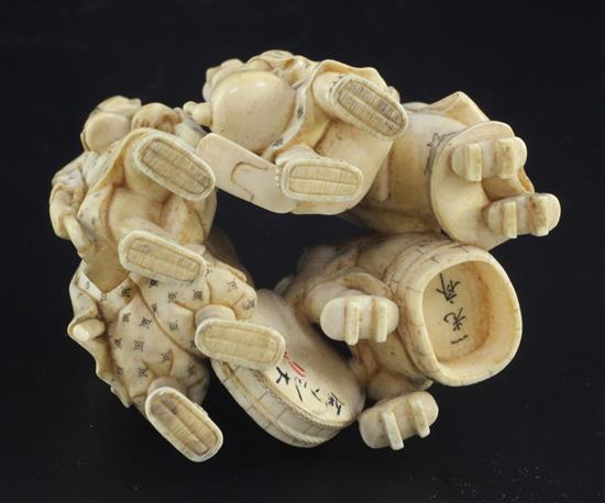 A good Japanese ivory okimono of five street pedlars or performers, signed Ikkosai, Meiji period, height 6.2cm